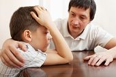 image of children  - Father comforts a sad child - JPG 