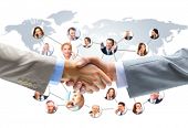 stock photo of handshake  - business people handshake with company team in background - JPG 