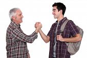 stock photo of handshake  - Mature man and young man handshaking - JPG 