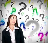 foto of decision  - businesswoman with question marks behind her hard decision - JPG 