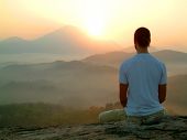 foto of religion  - man doing Meditation at Sunrise on hill - JPG 