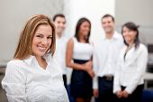 foto of business people  - Business woman at the office with a group behind him - JPG 
