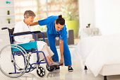 picture of help  - young caregiver helping elderly woman on wheelchair - JPG 