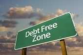 image of debt  - Debt Free Zone Green Road Sign In Front of Dramatic Clouds and Sky - JPG 