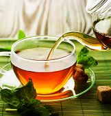 stock photo of pour  - Pouring Herbal Tea - JPG 
