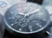 stock photo of watch  - Watch overlaid over Euro and dollar bills - JPG 