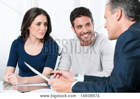 Picture or Photo of Financial consultant presents bank investments to a young couple