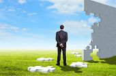 picture of puzzle  - Businessman with a puzzle pieces on the background - JPG 