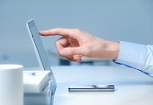 pic of finance  - Hand pointing on modern digital tablet pc at the workplace - JPG 