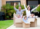 stock photo of family  - Happy family in cardboard boxes moving house - JPG 