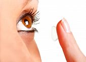 foto of insert  - Closeup of a woman inserting a contact lens in her eye - JPG 
