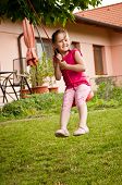 image of seesaw  - Happy smiling girl swinging on seesaw outdoors  - JPG 