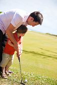 foto of golf  - Father teaching his son to play golf - JPG 
