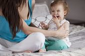 picture of calm  - Pretty baby girl crying while her mom tries to calm her - JPG 
