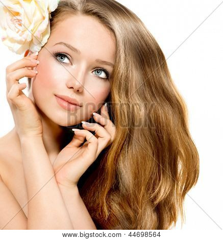 Picture or Photo of Beauty Girl. Beautiful Model with Rose Flower Touching her Face. Healthy Long Hair and Clear Skin. Youth. Isolated on White Background. Blowing Hair. Skincare concept