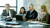stock photo of meeting  - A group of business people discuss things at a meeting - JPG 