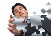 image of puzzle  - business man arranging puzzle pieces - JPG 