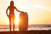 stock photo of beach  - Water sport bodyboarding surfer woman on summer beach vacation holidays travel - JPG 