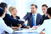 stock photo of meeting  - Two business colleagues shaking hands during meeting - JPG 