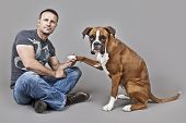 stock photo of dog  - An image of a handsome muscle man with his dog - JPG 