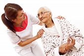 stock photo of medical doctors  - Young female doctor caring about a very old female patient - JPG 