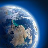 stock photo of earth  - A fragment of the Earth with high relief detailed surface translucent ocean and atmosphere illuminated by sunlight - JPG 
