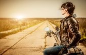 pic of outdoor  - Biker girl sits on a motorcycle - JPG 