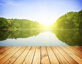 stock photo of nature  - Sunset on forest lake and wooden board background - JPG 