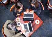 picture of meeting  - Overhead view of three business people meeting in a cafe - JPG 