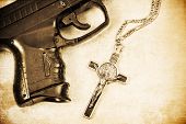 image of religion  - Crucifix and Hand gun in partial view of frame with Grunge image processing - JPG 