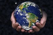 pic of earth  - a pair of hands holding the earth with the moon in the background - JPG 