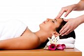 picture of facial  - Beautiful happy peaceful sleeping woman at a spa laying on wooden massage table with head on pillow wearing a towel getting a facial massage isolated - JPG 