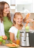 image of pressure  - Happy Family making fresh apple and carrot juice - JPG 