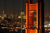 image of golden gate bridge  - A shot of the famous landmark Golden Gate Bridge with San Francisco city lights in the background - JPG 