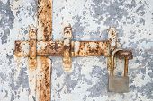 stock photo of latch  - Rusted latch and padlock on an old weathered door - JPG 