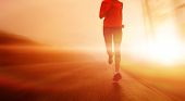 picture of fitness  - Athlete running on the road in morning sunrise training for marathon and fitness - JPG 