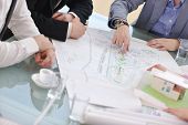 picture of meeting  - group of architect business team people on meeting looking model and desing of new real estate house - JPG 