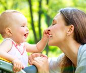 stock photo of outdoor  - Beautiful Mother And Baby outdoors - JPG 