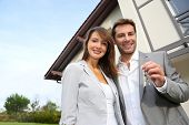 picture of future  - Couple in front of new home holding door keys - JPG 