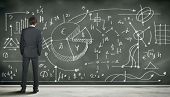 pic of science  - Business person standing against the blackboard with a lot of data written on it - JPG 