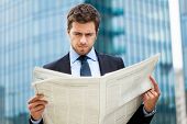 picture of newspaper  - Handsome man reading a newspaper - JPG 