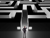 stock photo of business concept  - Business man in front of a huge maze thinking how to get through - JPG 