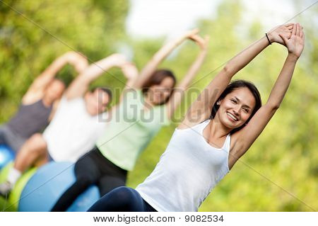 Picture or Photo of Group of people in a pilates class outdoors