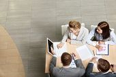 pic of partner  - Image of business partners sitting at table and planning work - JPG 