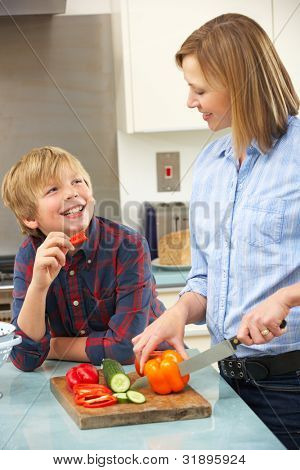 Picture or Photo of Mother and son preparing food in domestic kitchen