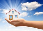 stock photo of investment  - The house in  hands on blue sky - JPG 