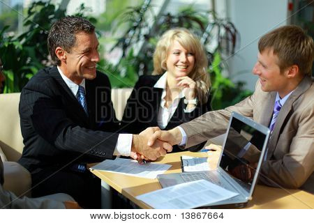 Picture or Photo of Business people shaking hands, finishing up a meeting
