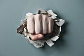 pic of pressure  - a wall is broken through by a fist - JPG 