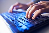 stock photo of keyboard  - Click! Hands of a man on a keyboard with blue backlighting.
** Note: Shallow depth of field - JPG 