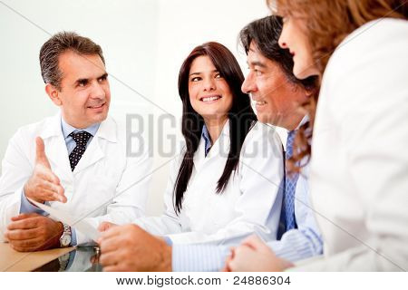 Picture or Photo of Group of doctors in a meeting with business people negotiating medical insurance